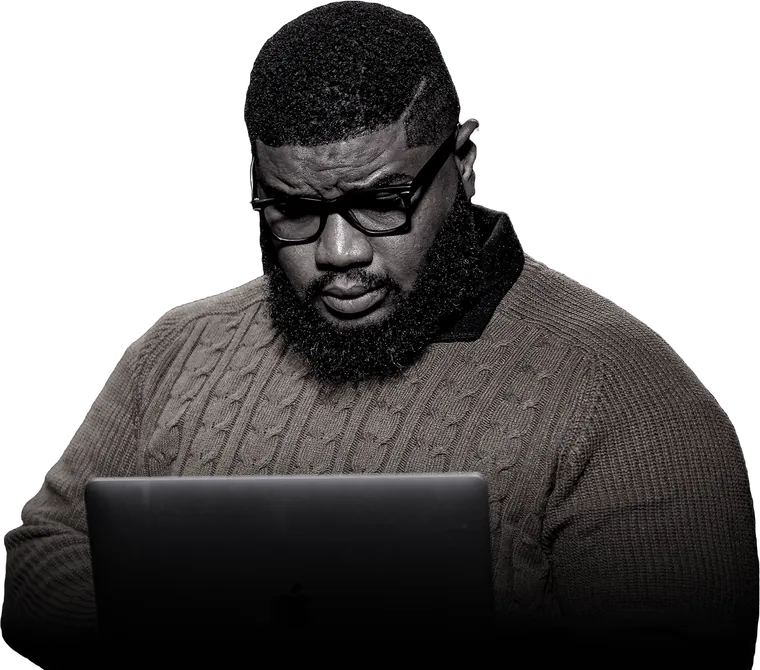 Kevin Eze at his laptop.